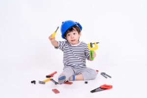 Child playing with tools